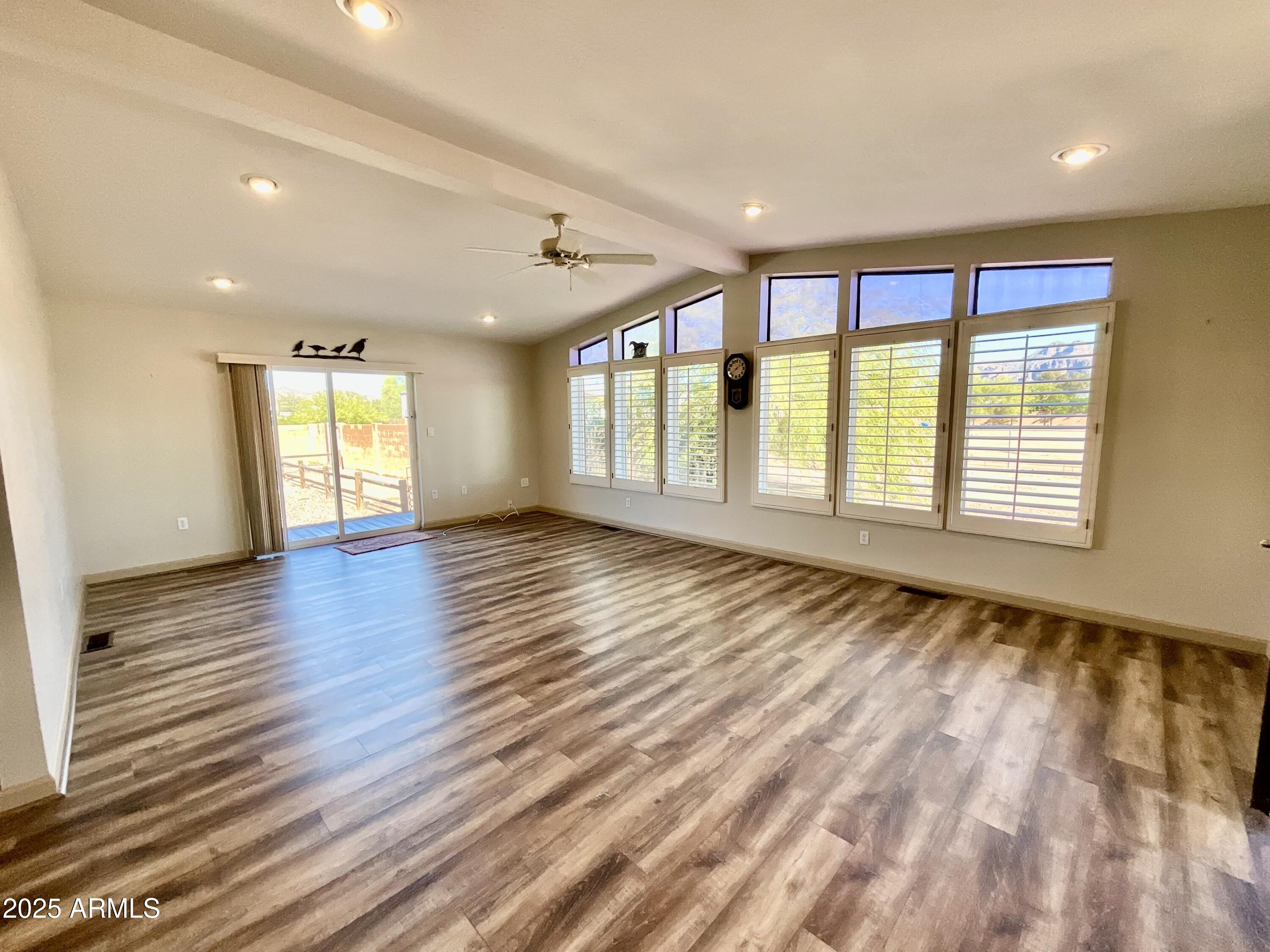 322 West Foothill Street Apache Junction, AZ 85120 - Photo 11 of 33 a view of an empty room with wooden floor and a window