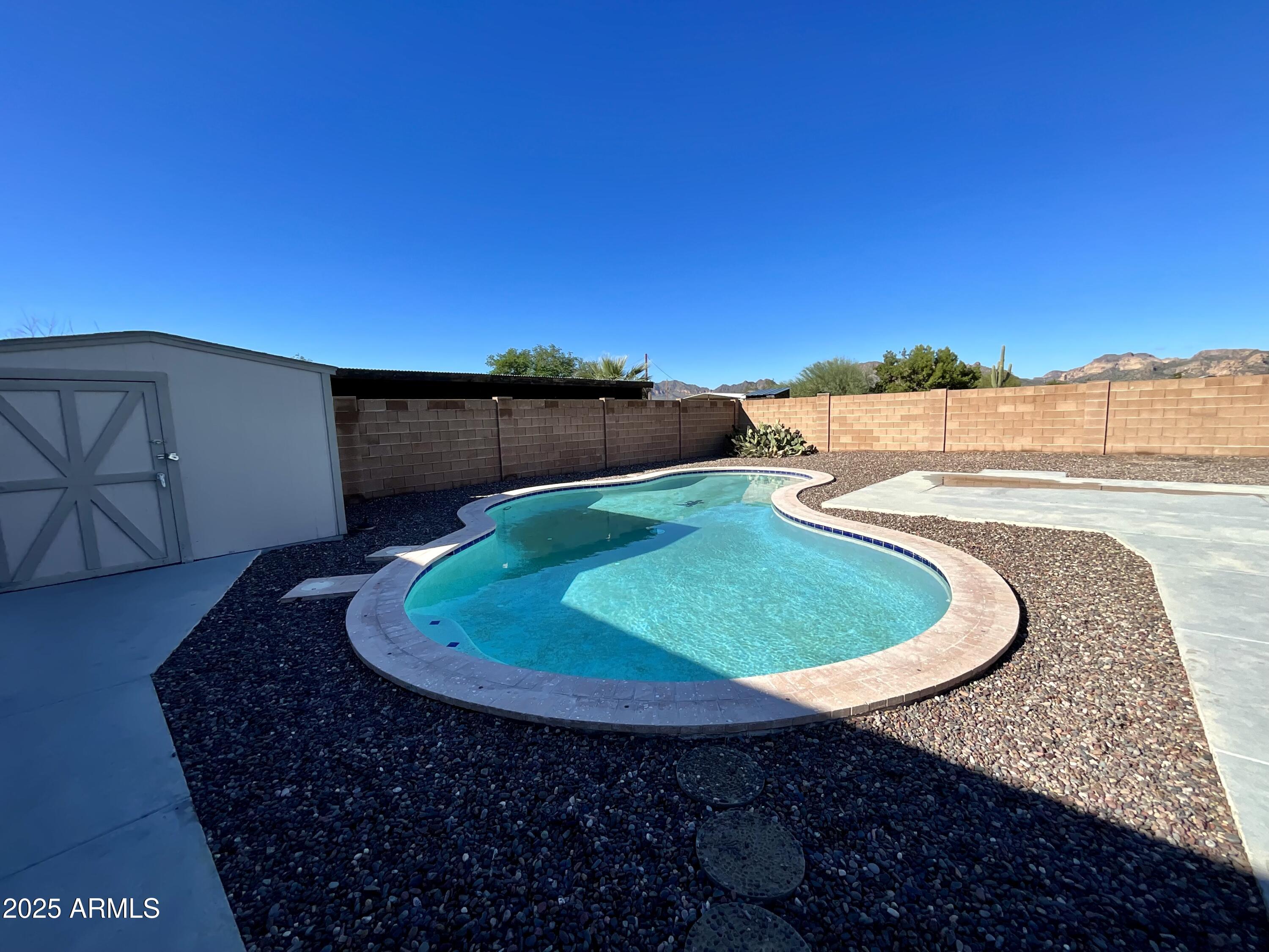 322 West Foothill Street Apache Junction, AZ 85120 - Photo 13 of 33 a view of a swimming pool with a yard
