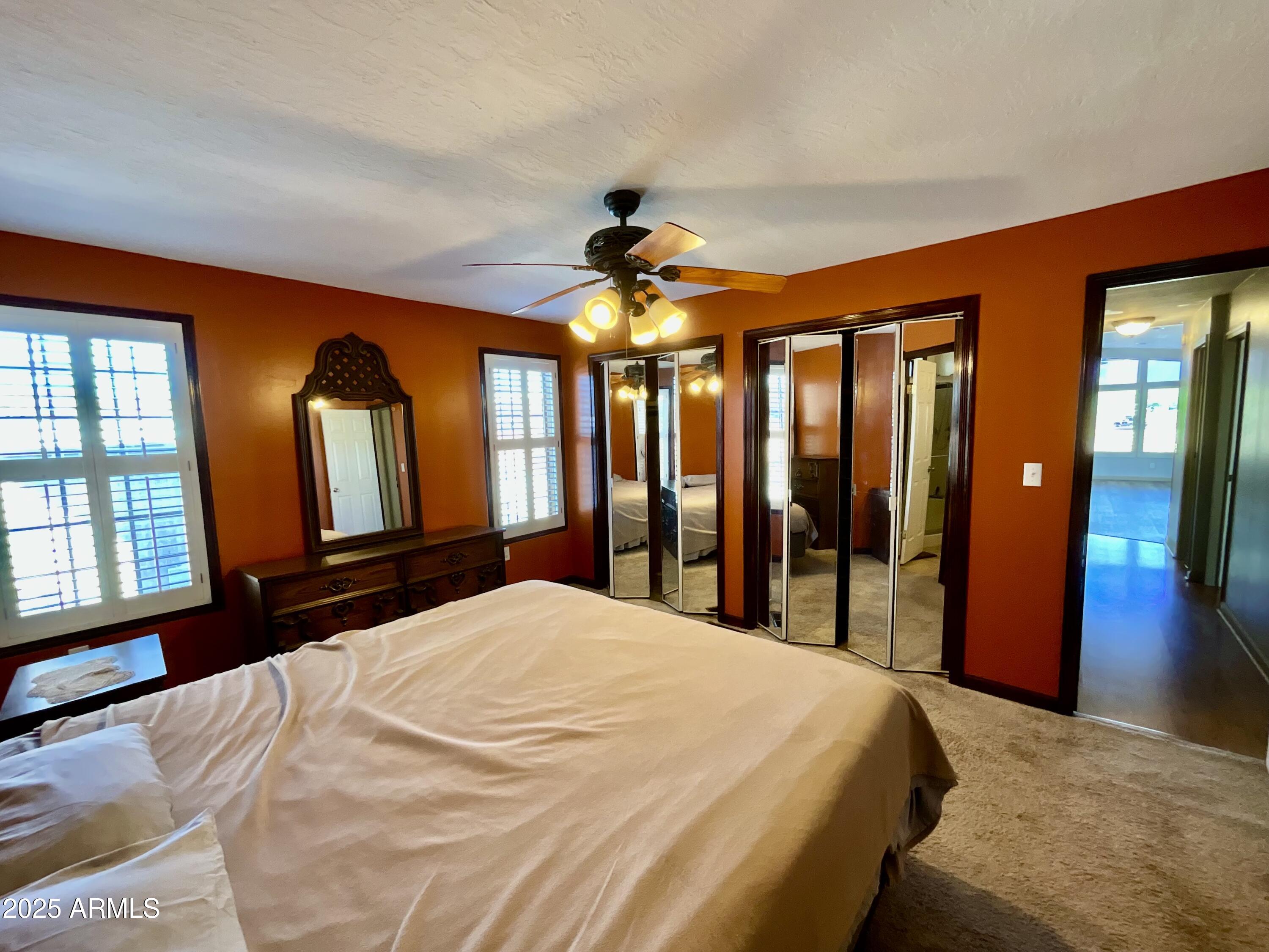 322 West Foothill Street Apache Junction, AZ 85120 - Photo 17 of 33 a bedroom with a large bed and a chandelier