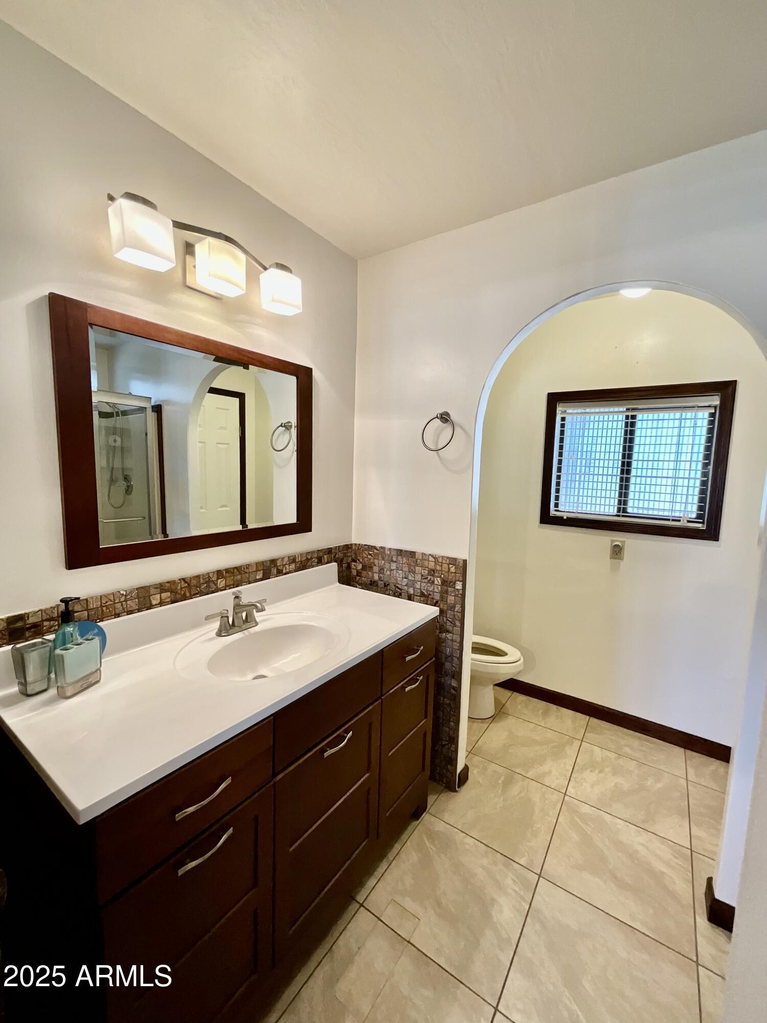 322 West Foothill Street Apache Junction, AZ 85120 - Photo 18 of 33 a bathroom with a sink vanity and a mirror