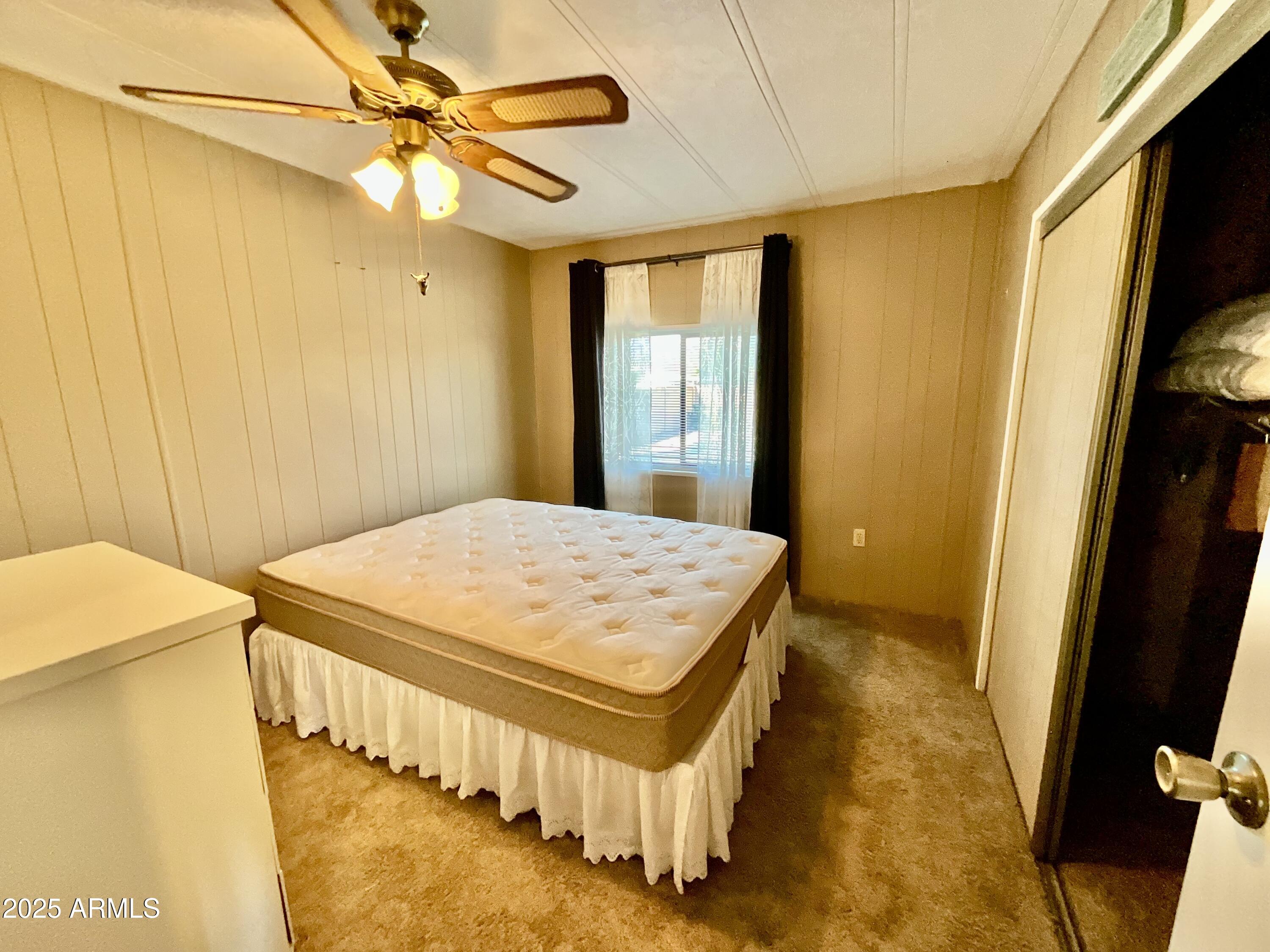 322 West Foothill Street Apache Junction, AZ 85120 - Photo 20 of 33 a bedroom with a bed and a chandelier