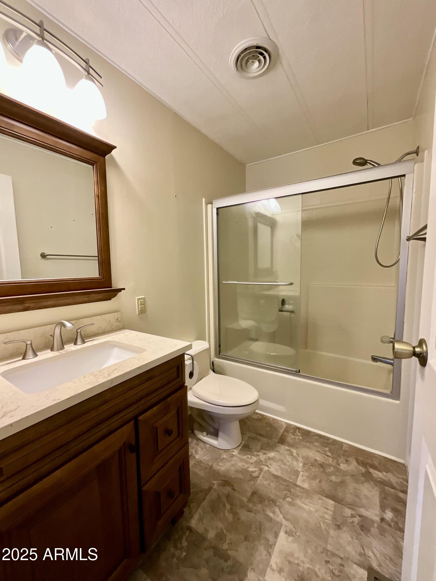 322 West Foothill Street Apache Junction, AZ 85120 - Photo 21 of 33 a bathroom with a granite countertop sink toilet and shower
