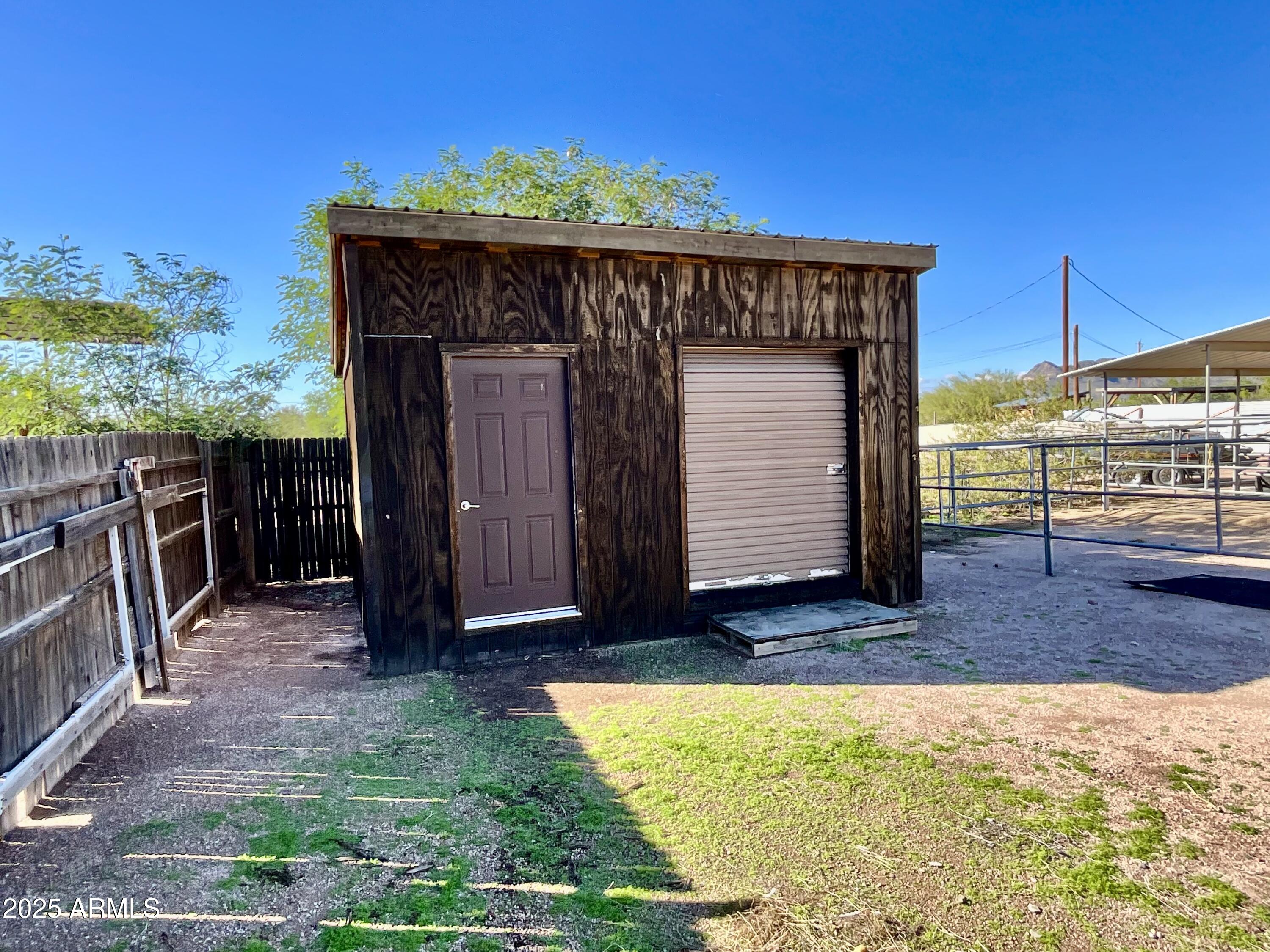 322 West Foothill Street Apache Junction, AZ 85120 - Photo 30 of 33 a view of a house with a wooden fence