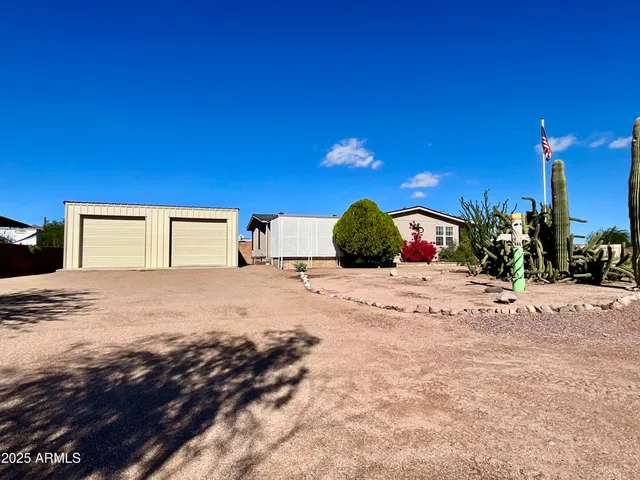a kitchen with a refrigerator and a stove top oven