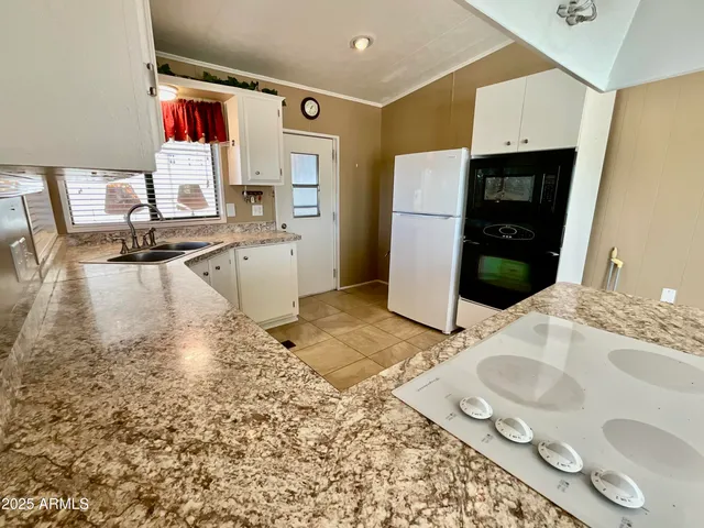 a kitchen with a stove a sink and a refrigerator