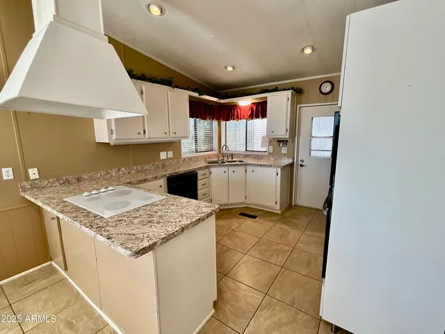 a kitchen with a sink window and cabinets