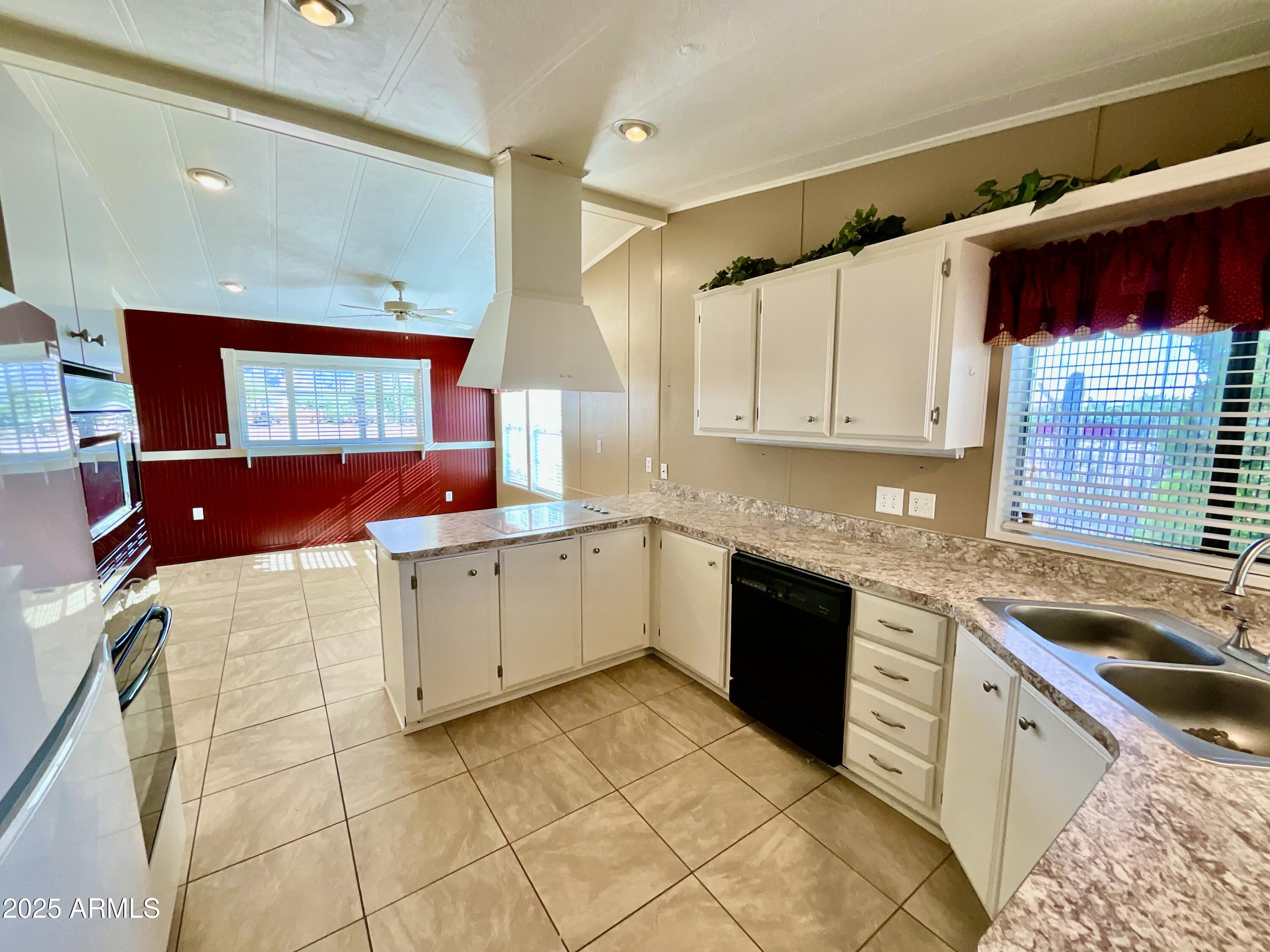 322 West Foothill Street Apache Junction, AZ 85120 - Photo 9 of 33 a kitchen with a sink window and cabinets