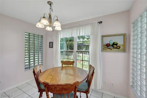 a view of a dining room with furniture wooden floor and chandelier