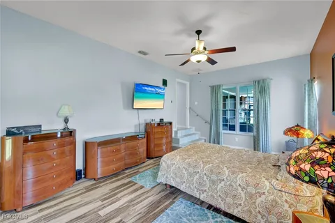 a bedroom with furniture and wooden floor