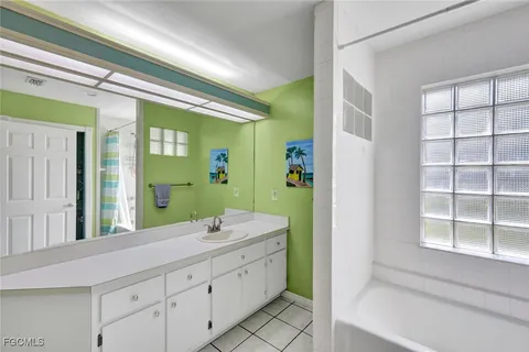 a bathroom with a double vanity sink and a large mirror