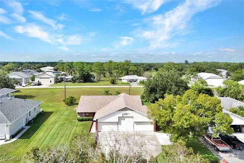 a view of a house with a yard and sitting area