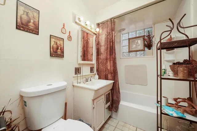 a bathroom with a sink mirror vanity and toilet