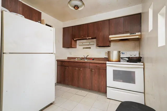 a kitchen with stainless steel appliances granite countertop a refrigerator sink and stove