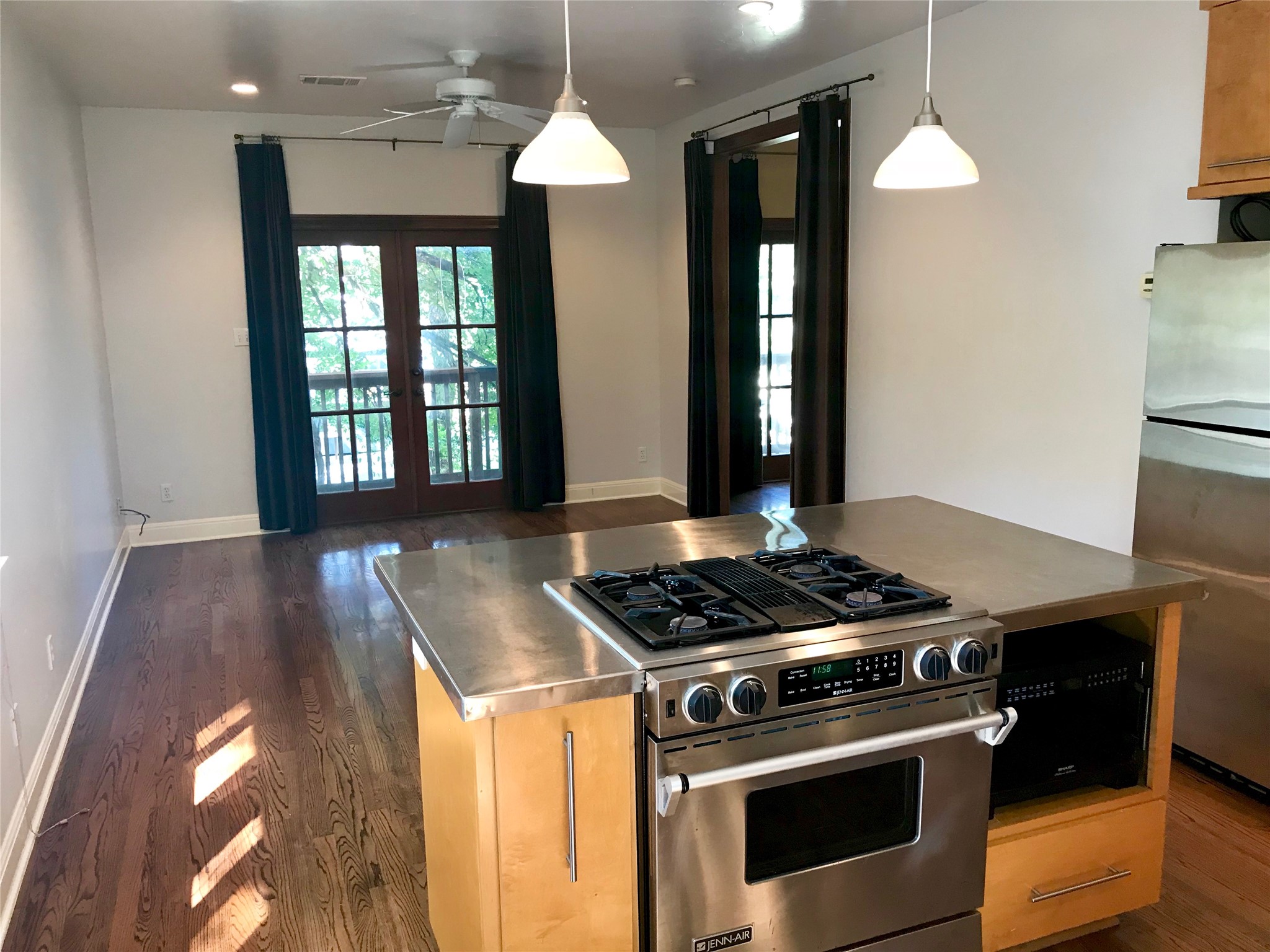 915 East 39th Street, Unit B Austin, TX 78751 - Photo 1 of 1 a kitchen with a stove and a wooden floor