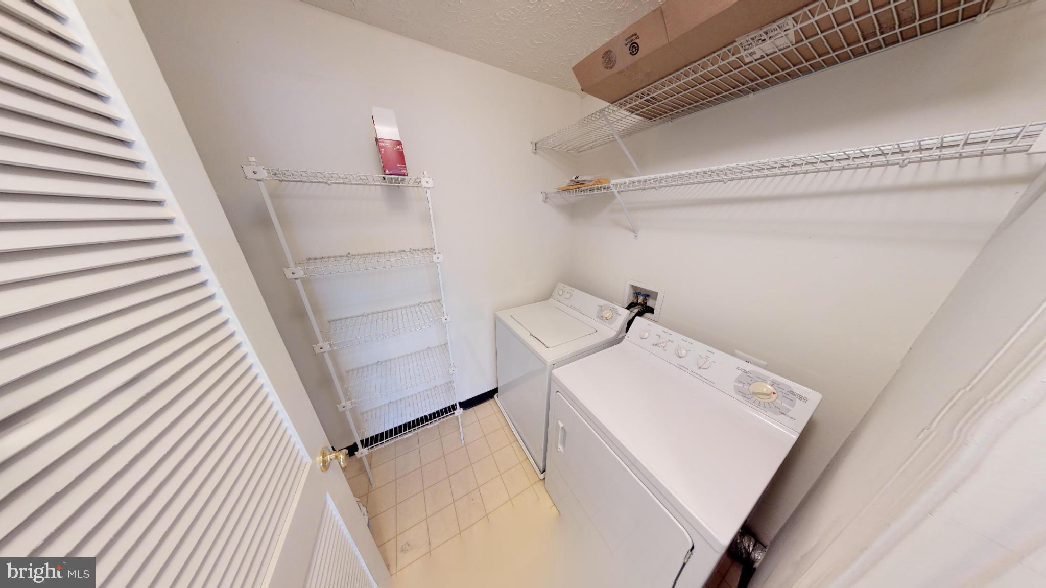 2443 Blue Spring Court, Unit 303 Odenton, MD 21113 - Photo 12 of 14 a utility room with dryer and washer