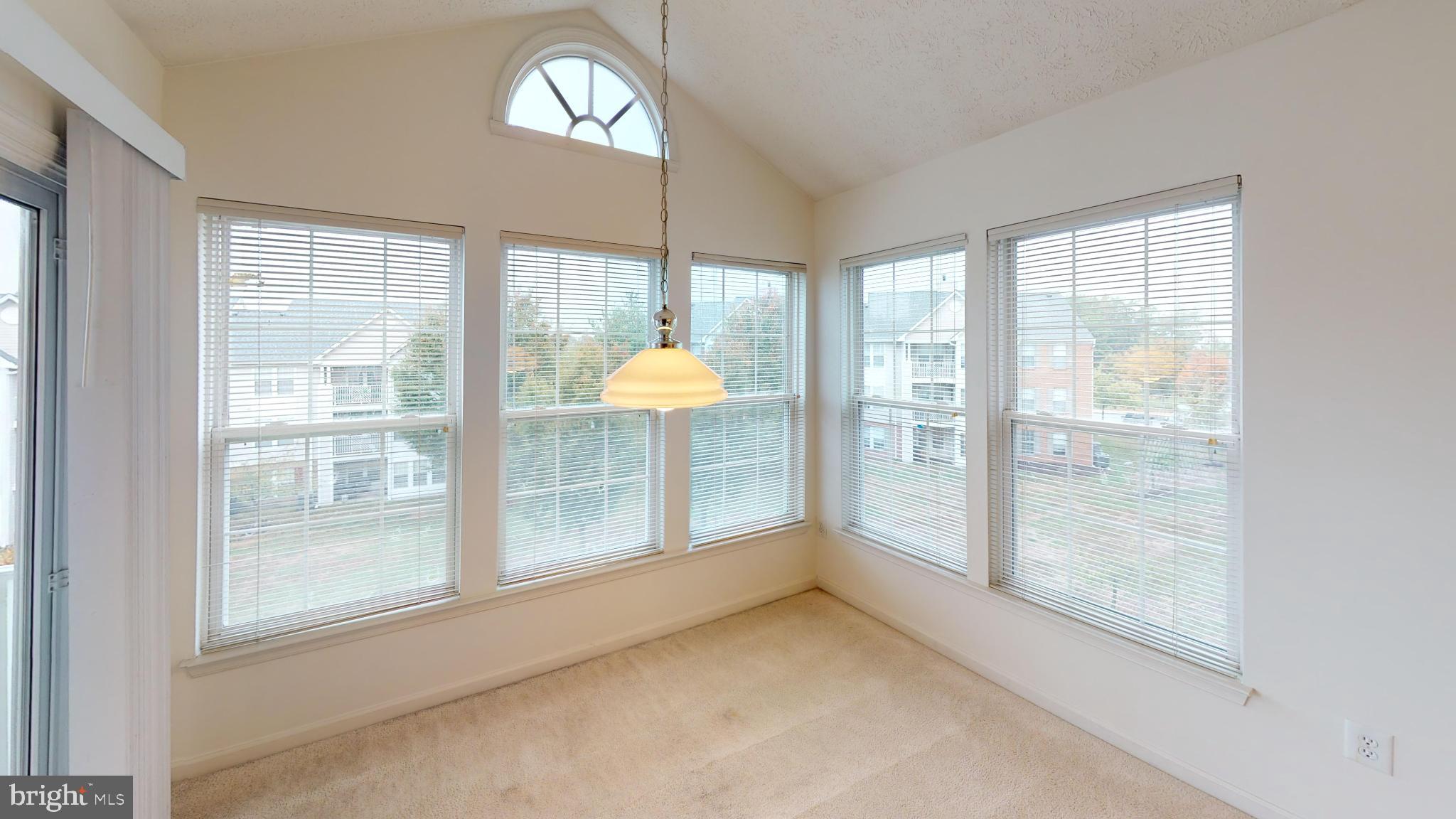 2443 Blue Spring Court, Unit 303 Odenton, MD 21113 - Photo 6 of 14 a view of empty room with wooden floor and fan
