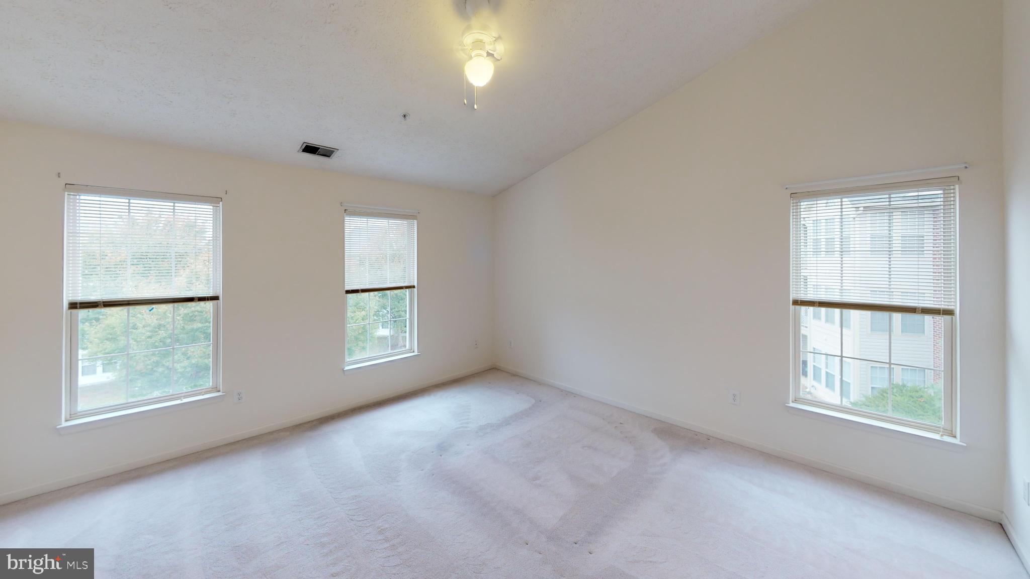 2443 Blue Spring Court, Unit 303 Odenton, MD 21113 - Photo 10 of 14 an empty room with windows and closet