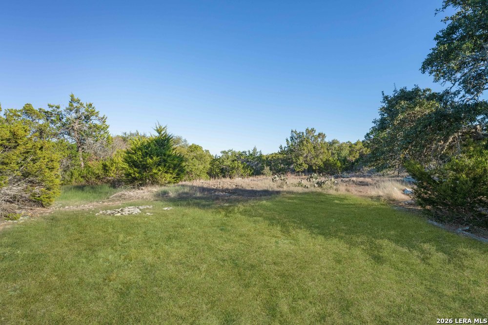 5387 Ranch Road Blanco, TX 78606 - Photo 4 of 7 a view of a lake with houses in the background