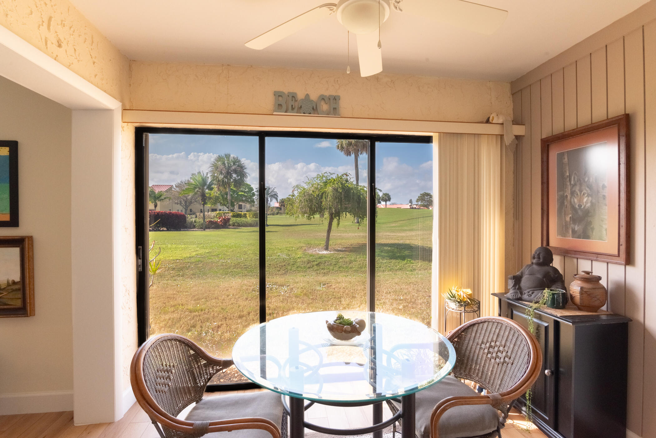5403 Southeast Miles Grant Road, Unit 111 Stuart, FL 34997 - Photo 11 of 29 a living room with furniture a floor to ceiling window and dining room