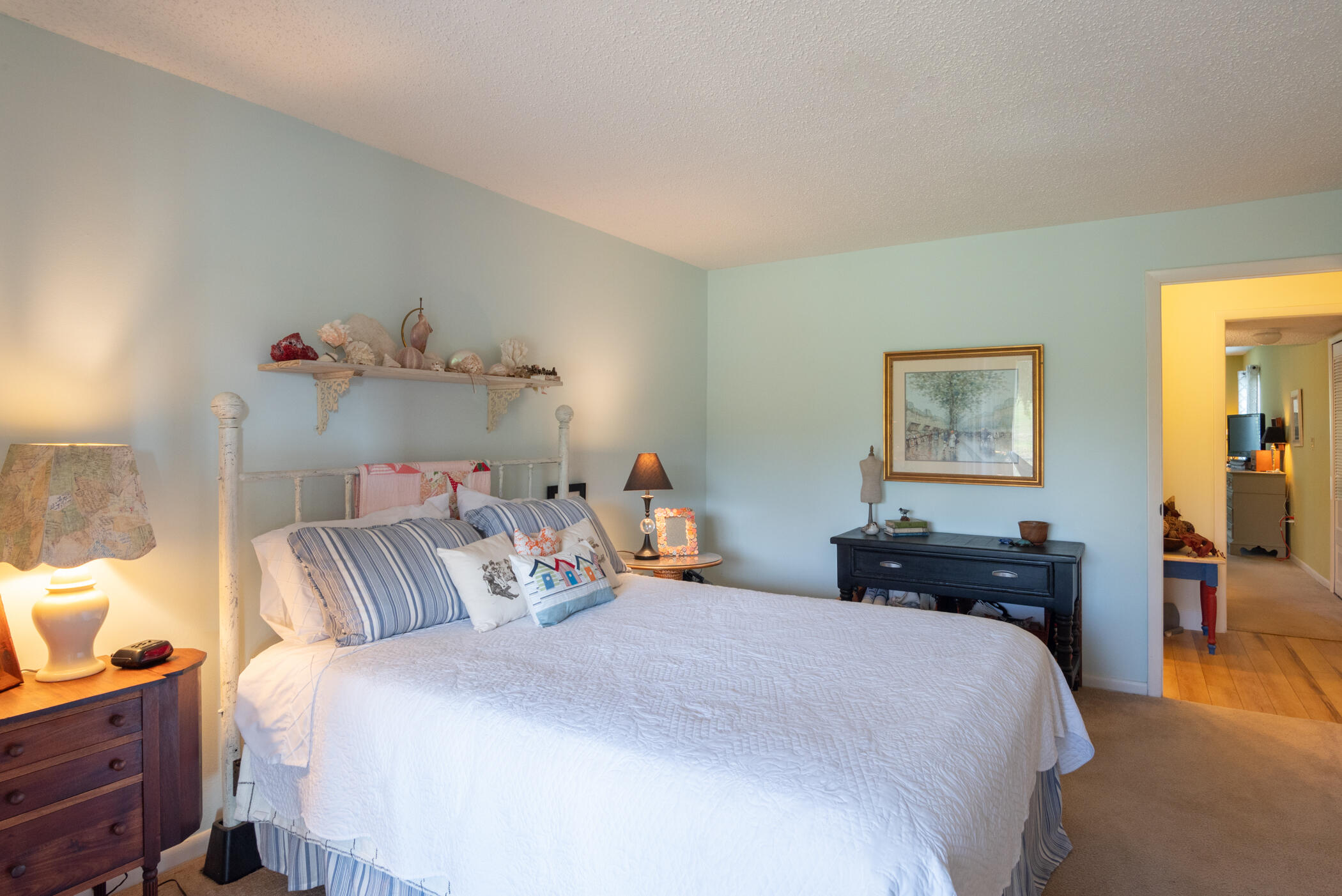 5403 Southeast Miles Grant Road, Unit 111 Stuart, FL 34997 - Photo 14 of 29 a bedroom with a bed and wooden floor