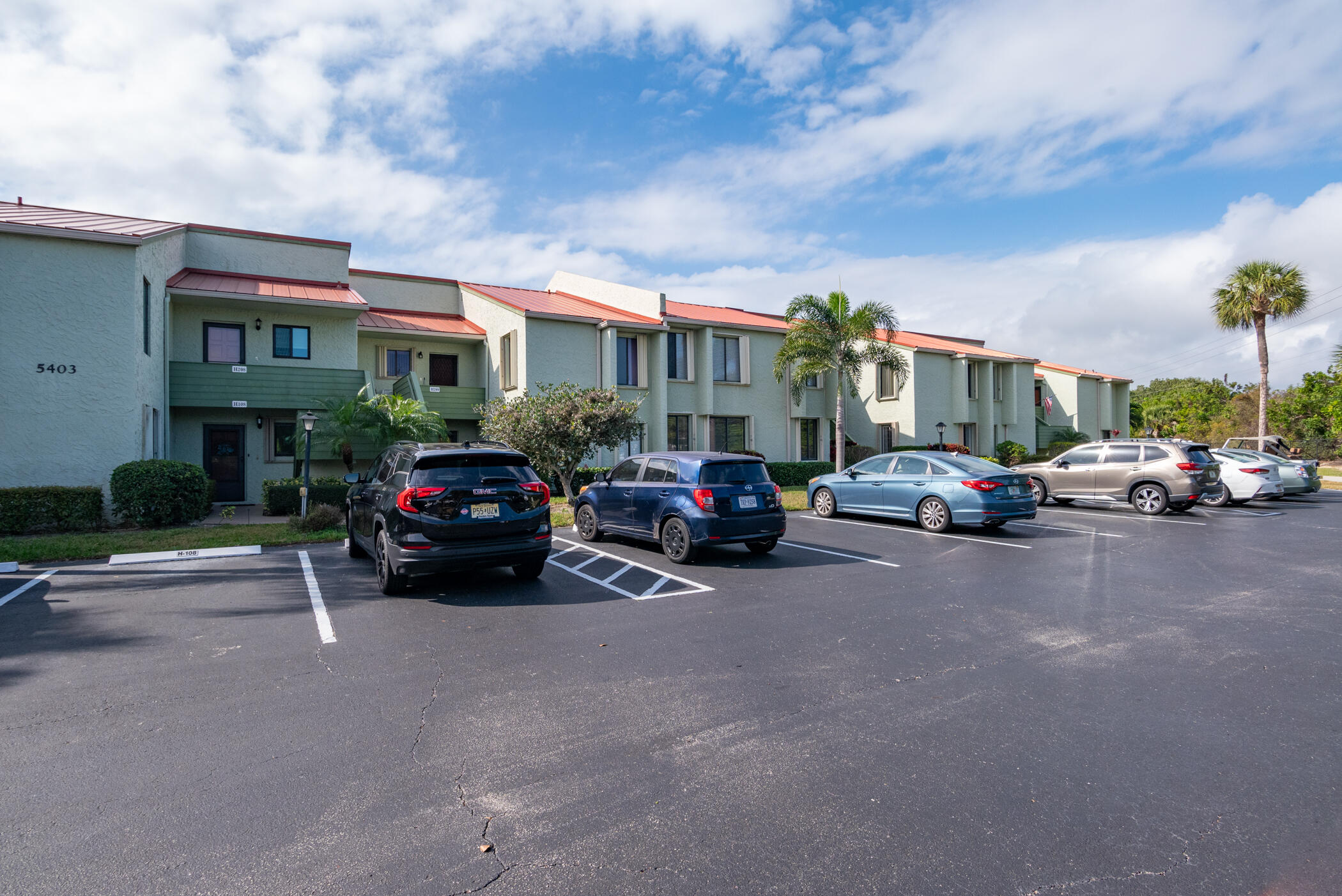 5403 Southeast Miles Grant Road, Unit 111 Stuart, FL 34997 - Photo 22 of 29 a car parked in front of a building