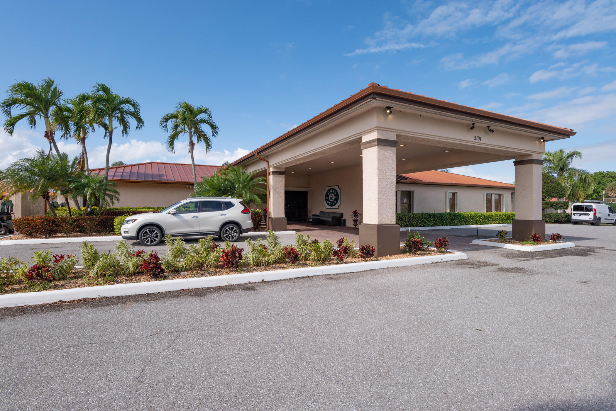 5403 Southeast Miles Grant Road, Unit 111 Stuart, FL 34997 - Photo 23 of 29 a couple of cars parked in front of a house