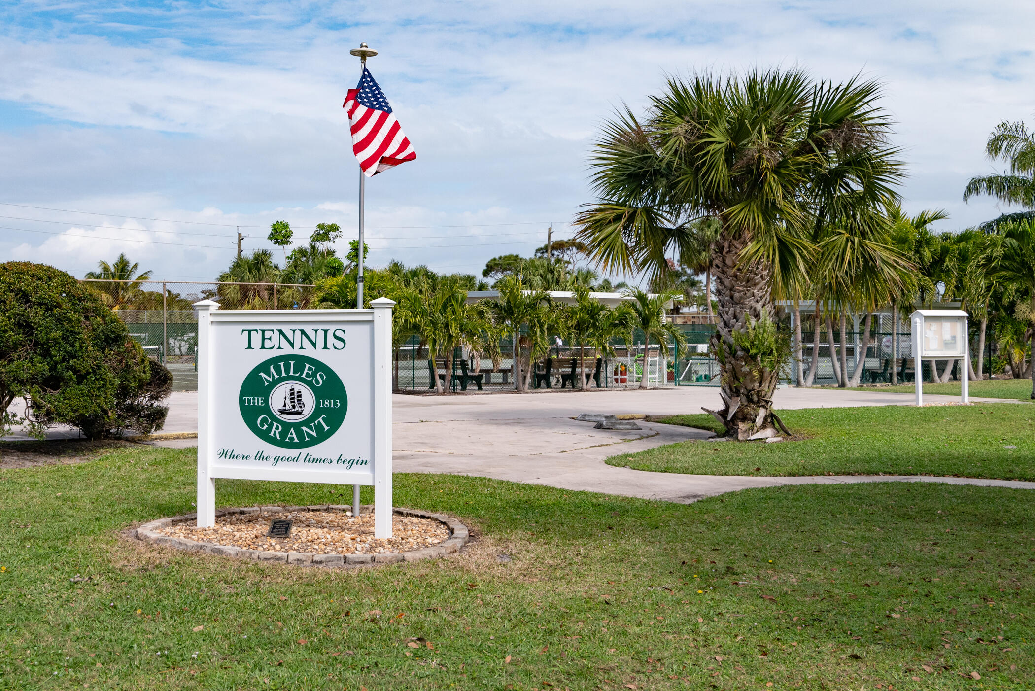 5403 Southeast Miles Grant Road, Unit 111 Stuart, FL 34997 - Photo 25 of 29 a sign that is sitting on the side of a road