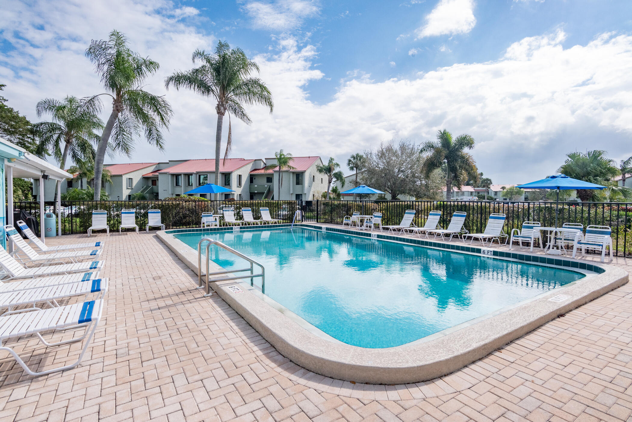 5403 Southeast Miles Grant Road, Unit 111 Stuart, FL 34997 - Photo 27 of 29 a view of a swimming pool with a patio