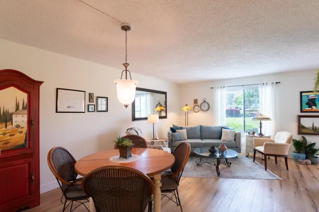 a dining room with furniture a window and wooden floor