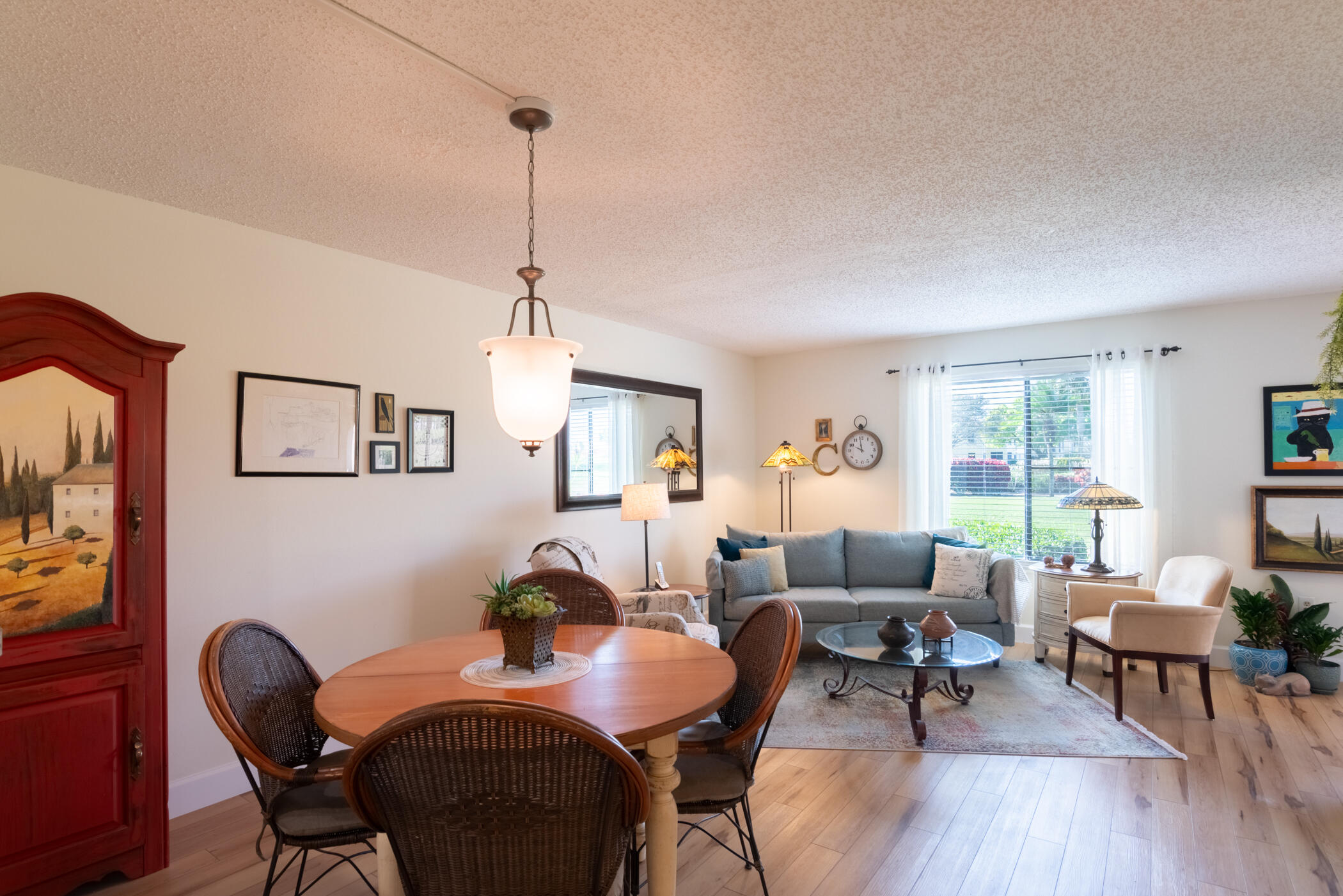 5403 Southeast Miles Grant Road, Unit 111 Stuart, FL 34997 - Photo 7 of 29 a dining room with furniture a window and wooden floor