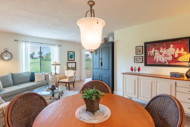 a dining room with furniture and wooden floor