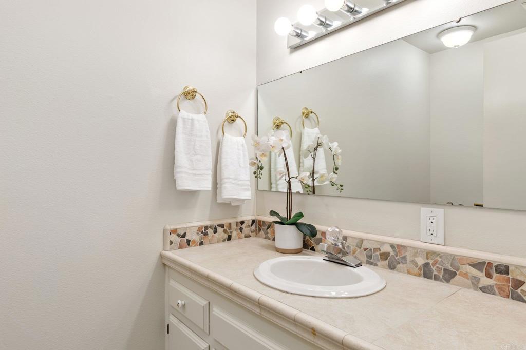1317 Rincon Road Escondido, CA 92025 - Photo 22 of 42 a bathroom with a sink and a mirror