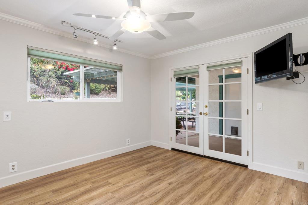 1317 Rincon Road Escondido, CA 92025 - Photo 23 of 42 a view of an empty room with a window and wooden floor