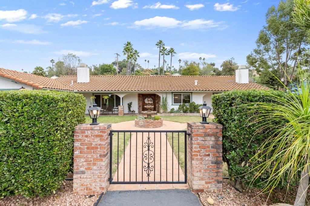 1317 Rincon Road Escondido, CA 92025 - Photo 4 of 42 a front view of a house with a yard