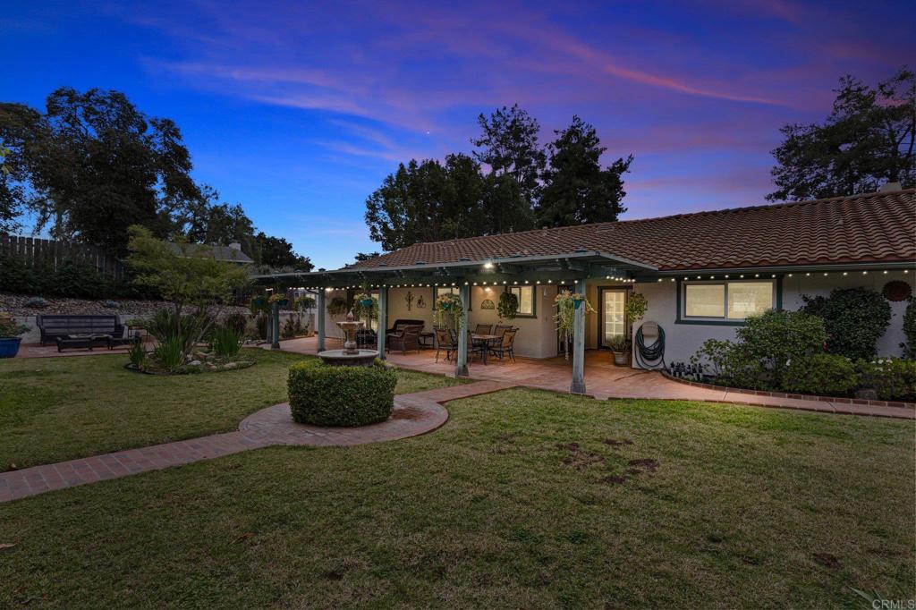 1317 Rincon Road Escondido, CA 92025 - Photo 42 of 42 a view of a patio with couches table and chairs under an umbrella