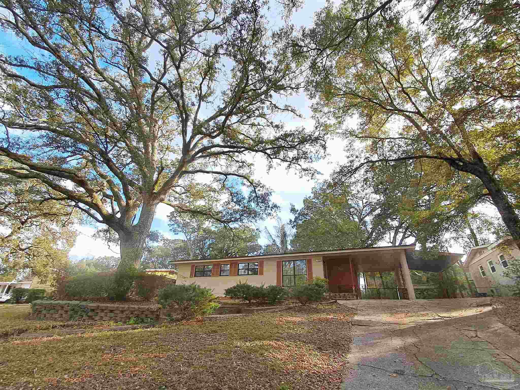 4929 Springhill Drive Pensacola, FL 32503 - Photo 1 of 16 a view of house with outdoor space and trees