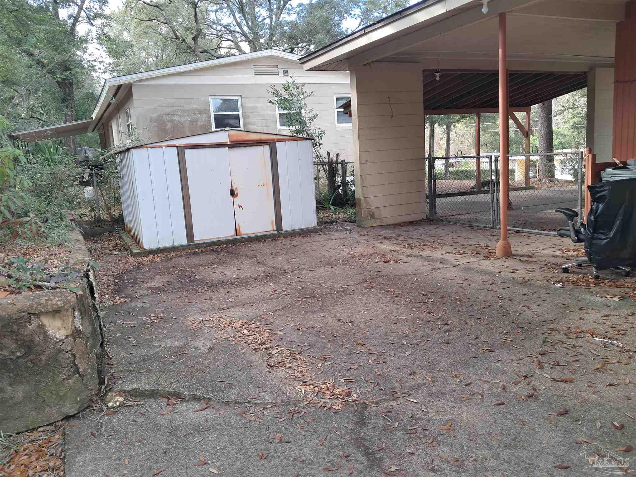 4929 Springhill Drive Pensacola, FL 32503 - Photo 13 of 16 a view of a house with backyard and furniture