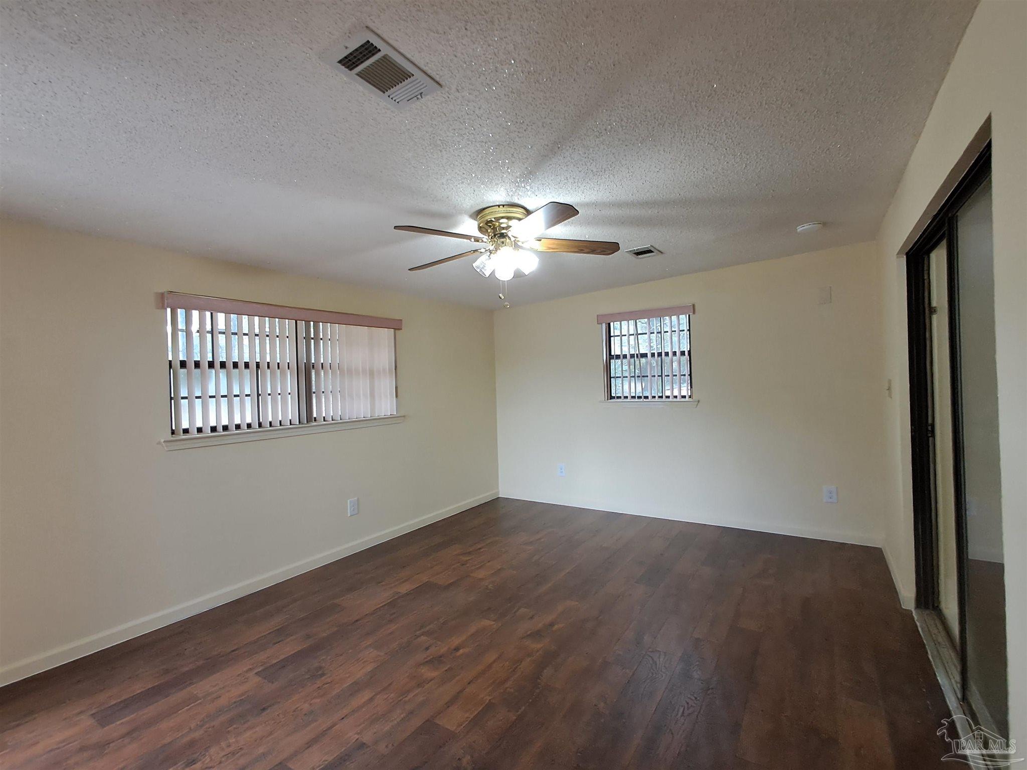 4929 Springhill Drive Pensacola, FL 32503 - Photo 16 of 16 a view of an empty room with a window and wooden floor