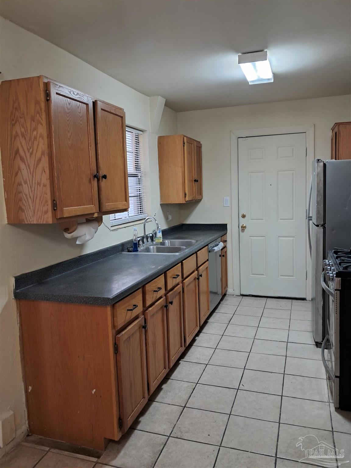 4929 Springhill Drive Pensacola, FL 32503 - Photo 6 of 16 a kitchen with stainless steel appliances a sink stove and cabinets