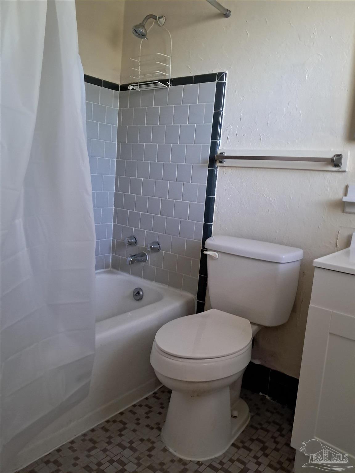 4929 Springhill Drive Pensacola, FL 32503 - Photo 8 of 16 a bathroom with a toilet and a shower