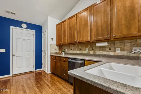 a kitchen with stainless steel appliances granite countertop a sink stove and cabinets