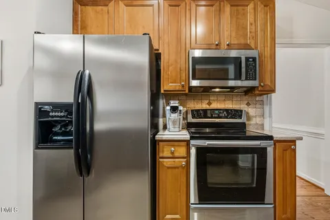 a kitchen with a refrigerator stove and microwave