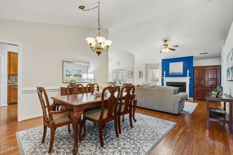 a view of a dining room with furniture wooden floor and chandelier