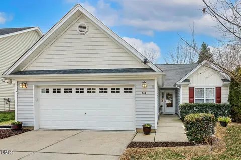 a front view of a house with garage