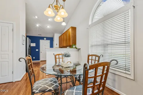 a view of a dining room with furniture and chandelier