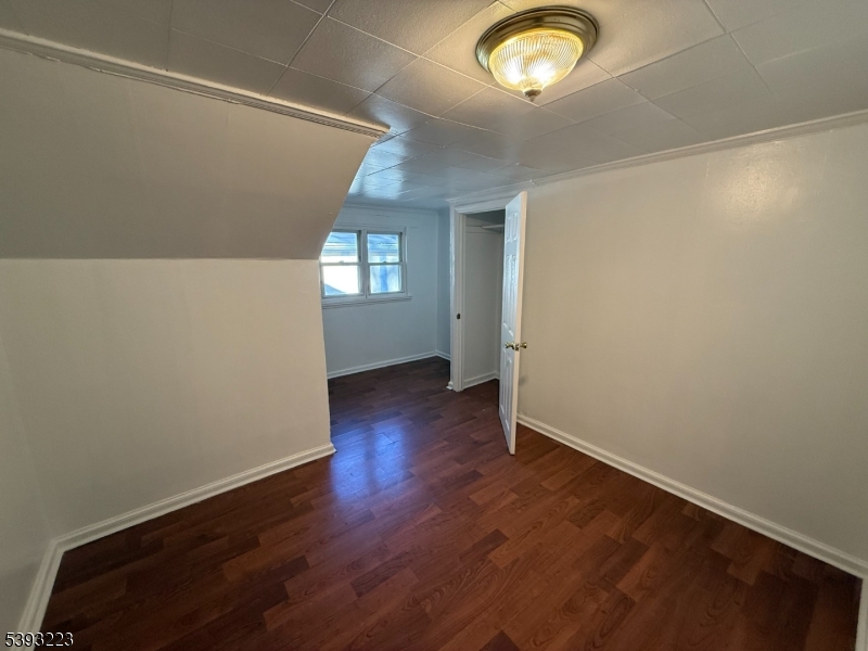 224 Westervelt Avenue Hawthorne, NJ 07506 - Photo 5 of 9 an empty room with wooden floor and windows