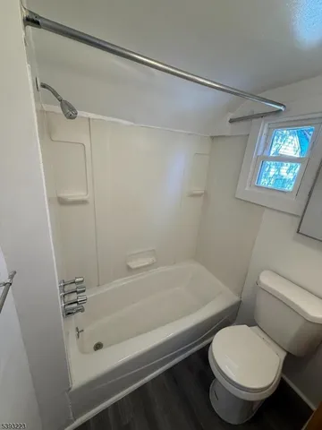 a bathroom with a toilet and a bathtub