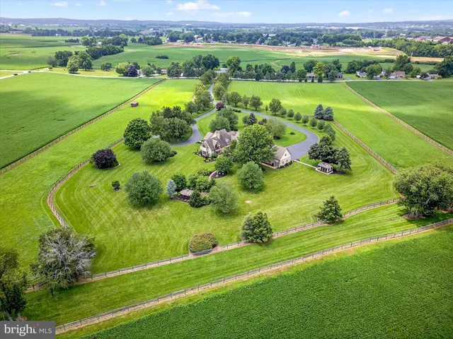 an aerial view of a golf course with a lake view