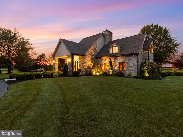 a bedroom with a bed window and table chair