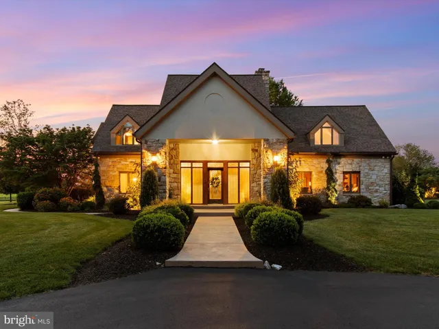 a bathroom with a granite countertop sink a mirror a vanity and a shower